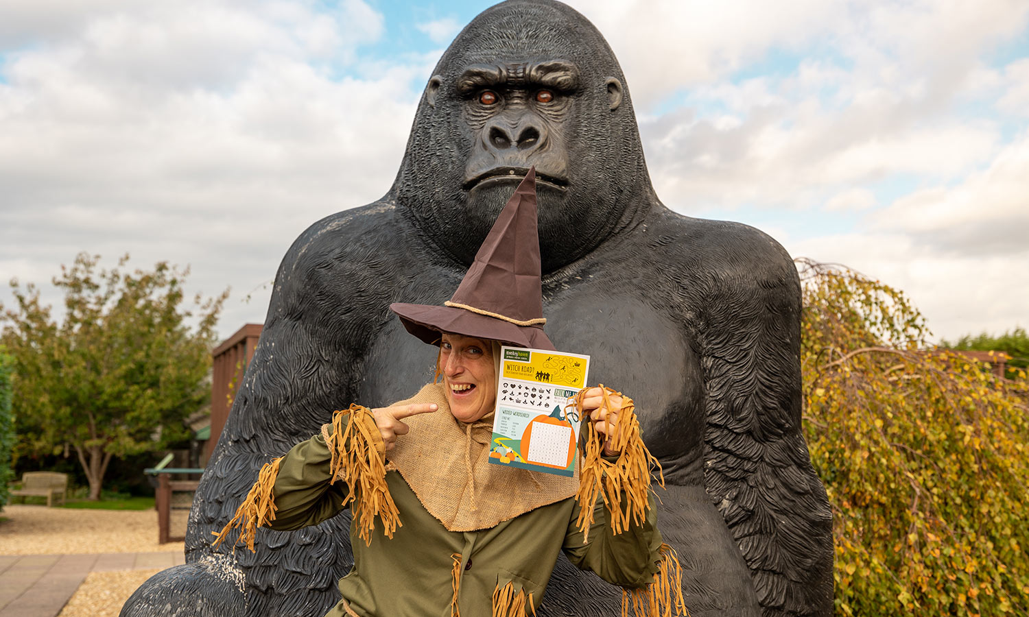 Wizard of oz character holding an activity sheet at Monkey Haven